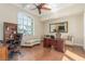 Comfortable home office boasts a large window, hardwood floors, and stylish furniture at 9992 Peak Lookout St, Las Vegas, NV 89178