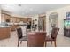 Open floorplan integrates the kitchen with stainless appliances, the dining area, and a staircase leading to the second floor at 9992 Peak Lookout St, Las Vegas, NV 89178