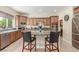 Well-appointed kitchen featuring wood cabinets, granite countertops, stainless steel appliances, and a convenient center island at 9992 Peak Lookout St, Las Vegas, NV 89178