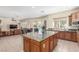 Spacious kitchen and living area showcases a seamless design, wood cabinets, and granite countertops, perfect for modern living at 9992 Peak Lookout St, Las Vegas, NV 89178