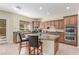 Spacious kitchen features wood cabinets, granite countertops, stainless steel appliances, and a convenient center island at 9992 Peak Lookout St, Las Vegas, NV 89178