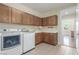 Convenient laundry area equipped with washer, dryer, sink, and plenty of storage cabinets at 9992 Peak Lookout St, Las Vegas, NV 89178