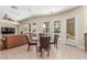 Open-concept living area with access to kitchen features a dining table, providing seamless flow for entertaining and everyday living at 9992 Peak Lookout St, Las Vegas, NV 89178