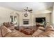 Inviting living room with hardwood floors, a cozy fireplace, and ample natural light, perfect for relaxing and entertaining at 9992 Peak Lookout St, Las Vegas, NV 89178