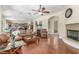 Spacious living room with fireplace, hardwood floors, and comfortable seating, great for entertaining at 9992 Peak Lookout St, Las Vegas, NV 89178