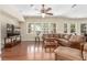Bright living room with hardwood floors, large windows and a comfortable sectional sofa at 9992 Peak Lookout St, Las Vegas, NV 89178