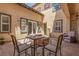 Charming outdoor patio with a stone fireplace, comfortable seating, and well-maintained landscaping at 9992 Peak Lookout St, Las Vegas, NV 89178