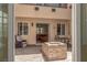 Inviting outdoor patio with brick flooring, cozy seating, and a stone fire pit feature at 9992 Peak Lookout St, Las Vegas, NV 89178