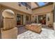 Spacious patio area with a stone fire pit, water feature, and easy access to indoor living spaces at 9992 Peak Lookout St, Las Vegas, NV 89178