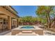 A stunning swimming pool features an attached spa and multiple access points at 9992 Peak Lookout St, Las Vegas, NV 89178