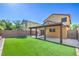 Home featuring a patio with artificial grass, fenced for privacy, perfect for outdoor entertaining at 10072 Pelham Park Ave, Las Vegas, NV 89148