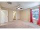 Neutral bedroom featuring plush carpet, ceiling fan, and bright natural light at 10072 Pelham Park Ave, Las Vegas, NV 89148