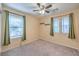 Cozy bedroom with carpeted floors, ceiling fan and ample natural light at 10072 Pelham Park Ave, Las Vegas, NV 89148