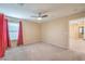 Neutral bedroom featuring plush carpet, ceiling fan, and bright natural light at 10072 Pelham Park Ave, Las Vegas, NV 89148