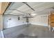 Spacious garage with ample storage and an overhead rack and an automatic door opener at 10072 Pelham Park Ave, Las Vegas, NV 89148
