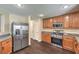 Well-lit kitchen features stainless steel appliances, granite countertops, and wood cabinets at 10072 Pelham Park Ave, Las Vegas, NV 89148