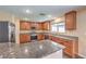 Modern kitchen with granite countertops, stainless steel appliances, and ample cabinet space at 10072 Pelham Park Ave, Las Vegas, NV 89148