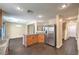 Bright kitchen boasts stainless steel appliances, wood cabinets, and breakfast bar with granite counters at 10072 Pelham Park Ave, Las Vegas, NV 89148