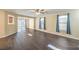 Open-concept living space with hardwood floors and sliding glass doors to the backyard at 10072 Pelham Park Ave, Las Vegas, NV 89148