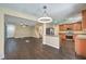 Open concept living space showcasing hardwood floors, a kitchen, and stairs to the upper level at 10072 Pelham Park Ave, Las Vegas, NV 89148