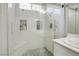 Nicely updated glass shower featuring subway tile and gray stone flooring at 10605 Moon Flower Arbor Pl, Las Vegas, NV 89144