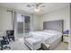 Bright bedroom with sliding door to pool, ceiling fan, and upholstered headboard at 10605 Moon Flower Arbor Pl, Las Vegas, NV 89144