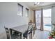 Cozy dining area with seating for four, large windows, and a view of the pool at 10605 Moon Flower Arbor Pl, Las Vegas, NV 89144
