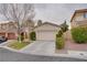 Inviting single-story home with a neutral stucco exterior, a two-car garage, and low maintenance desert landscaping at 10605 Moon Flower Arbor Pl, Las Vegas, NV 89144