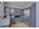 Well-lit kitchen featuring gray cabinets, stainless steel appliances, and ample counter space at 10605 Moon Flower Arbor Pl, Las Vegas, NV 89144