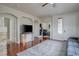 Bright living room with hardwood floors, a modern TV console, and arched doorways at 10605 Moon Flower Arbor Pl, Las Vegas, NV 89144