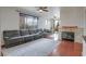 Bright and spacious living room with a large sectional sofa, a cozy fireplace, and sliding glass doors at 10605 Moon Flower Arbor Pl, Las Vegas, NV 89144