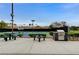 Outdoor tennis court with blue and green surface, barbecue and picnic tables, perfect for enjoying a match and a meal at 10671 Capesthorne Way, Las Vegas, NV 89135
