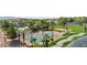 Community pool, tennis, basketball, and sand volleyball courts surrounded by green space, palm trees, and houses at 1187 Mohave Dr, Mesquite, NV 89027