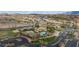 Overhead view showcasing community tennis courts and pool area with surrounding desert landscape, offering a lifestyle of leisure and recreation at 1187 Mohave Dr, Mesquite, NV 89027
