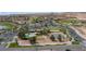 A captivating aerial view of community amenities, including pool, tennis courts, and clubhouse, nestled within a scenic landscape at 1187 Mohave Dr, Mesquite, NV 89027