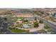 Beautiful aerial view of community pool, tennis courts and desert landscape with scenic views from an elevated vantage point at 1187 Mohave Dr, Mesquite, NV 89027
