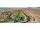 Aerial view of a community with golf course, lake, mature landscaping, and mountain views at 1187 Mohave Dr, Mesquite, NV 89027