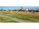 View of a property's backyard situated on a golf course with mature desert landscaping at 1187 Mohave Dr, Mesquite, NV 89027