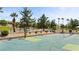 Outdoor basketball court and tennis courts with desert landscaping, palm trees, and well-maintained fencing at 1187 Mohave Dr, Mesquite, NV 89027