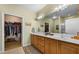 Bathroom featuring double sinks, wood cabinets, and a walk-in closet at 1187 Mohave Dr, Mesquite, NV 89027