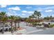 Attractive clubhouse entrance with palm trees and lush landscaping, situated next to a golf course with golf carts parked nearby at 1187 Mohave Dr, Mesquite, NV 89027