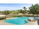 Community pool and hot tub with lounge chairs and landscaped surroundings in a sunny neighborhood at 1187 Mohave Dr, Mesquite, NV 89027