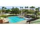 Beautiful community pool and hot tub with a shaded bar area, lounge chairs, and lush landscaping at 1187 Mohave Dr, Mesquite, NV 89027