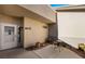 Cozy courtyard with a small table and chairs, potted plants, and a 'welcome' sign for a warm entry at 1187 Mohave Dr, Mesquite, NV 89027