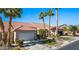 Charming home featuring a two-car garage, landscaped front yard with desert landscaping and vibrant palm trees at 1187 Mohave Dr, Mesquite, NV 89027