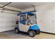 Garage featuring a clean, well-maintained golf cart ready for leisure and storage cabinets along the wall at 1187 Mohave Dr, Mesquite, NV 89027