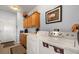 Bright laundry room with washer, dryer, overhead cabinets and tile flooring at 1187 Mohave Dr, Mesquite, NV 89027