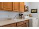 Bright laundry room with washer, dryer, lots of cabinets and a utility sink at 1187 Mohave Dr, Mesquite, NV 89027