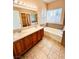 Bathroom featuring a double vanity with a bathtub and a large window at 1318 Pine Terrace Ct, North Las Vegas, NV 89031