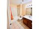 Bathroom with a bathtub and shower with a tile floor and wood vanity at 1318 Pine Terrace Ct, North Las Vegas, NV 89031